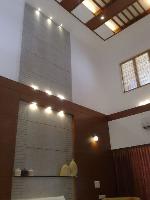 the high ceiling in the living room with the granite cladding and wood paneling.